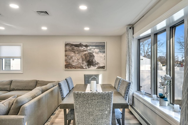 dining area featuring recessed lighting, visible vents, light wood finished floors, and a baseboard radiator