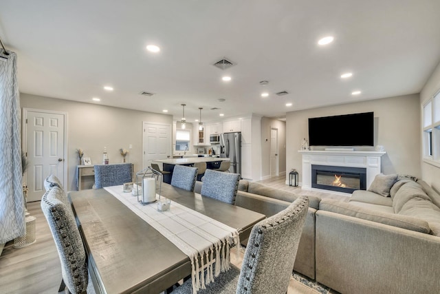 dining room featuring light wood-type flooring, visible vents, and recessed lighting