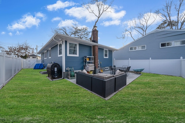 rear view of property featuring a lawn, a patio, a fenced backyard, a chimney, and an outdoor hangout area