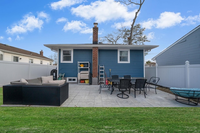 rear view of property featuring a patio, a yard, and outdoor lounge area