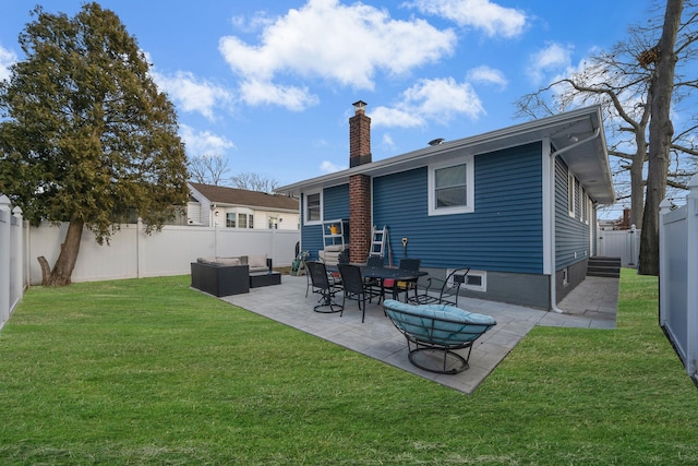 rear view of property with a patio, a chimney, a lawn, an outdoor hangout area, and a fenced backyard