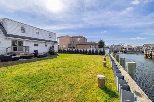 dock area with a yard, outdoor lounge area, a water view, fence, and a residential view