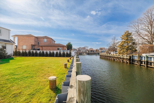 dock area with a residential view, a water view, and a yard