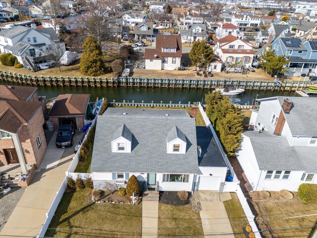 drone / aerial view with a residential view and a water view