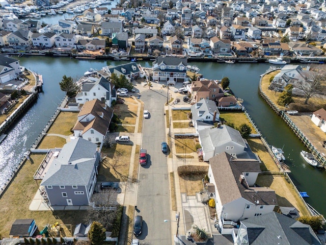 drone / aerial view featuring a water view and a residential view