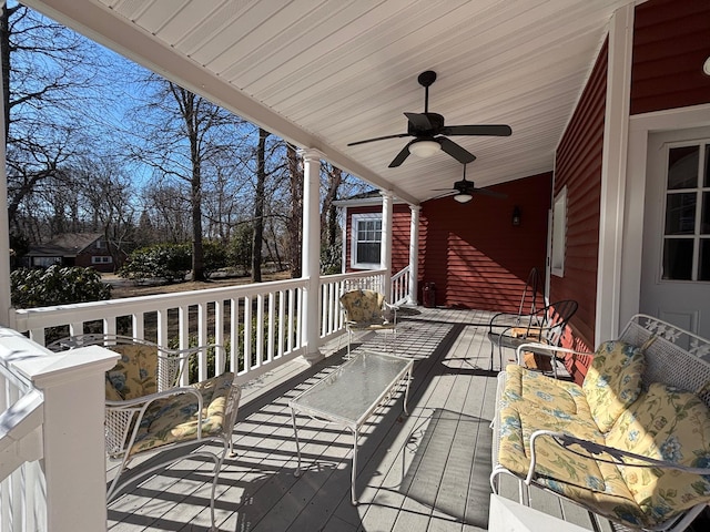 wooden terrace featuring a ceiling fan