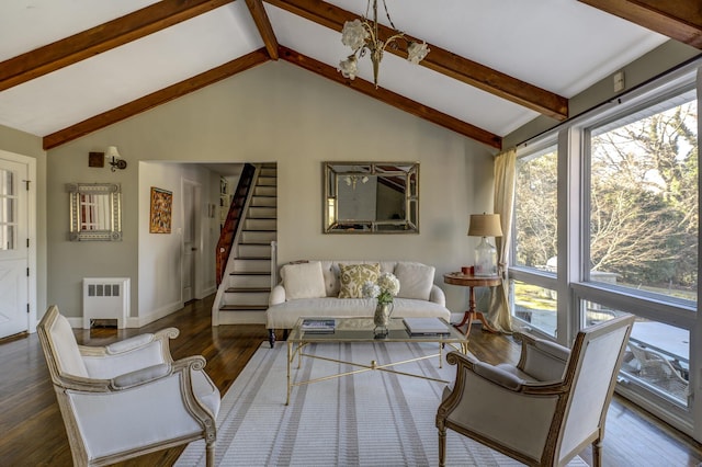 living area with radiator, lofted ceiling with beams, stairway, wood finished floors, and a chandelier