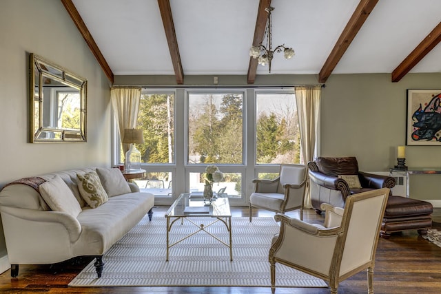 living area featuring vaulted ceiling with beams, plenty of natural light, and wood finished floors