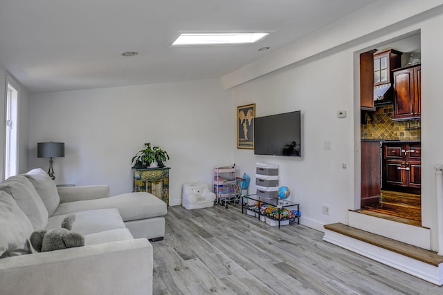 living room featuring light wood-type flooring and baseboards