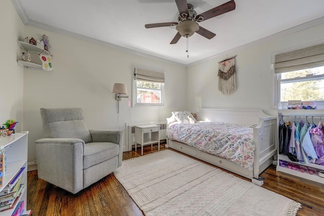 bedroom featuring multiple windows, crown molding, and wood finished floors