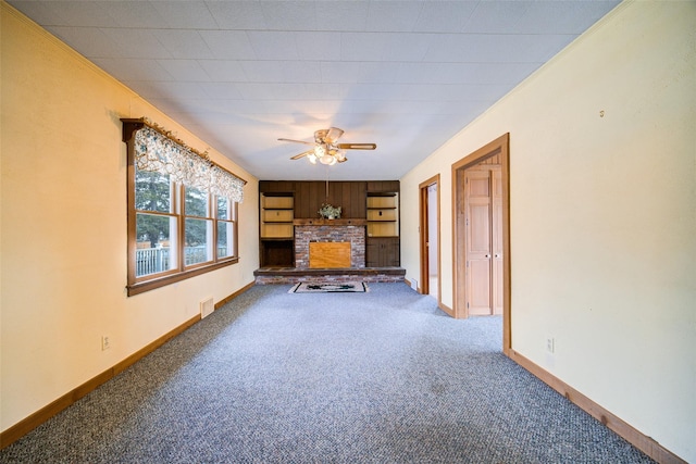 unfurnished living room featuring visible vents, carpet flooring, baseboards, a brick fireplace, and ceiling fan