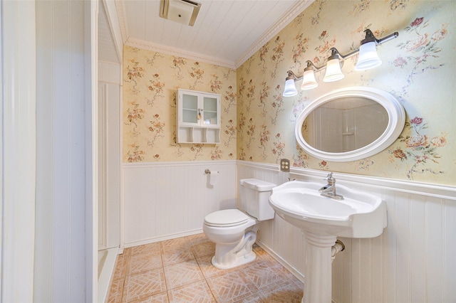 bathroom with wallpapered walls, tile patterned floors, toilet, and a wainscoted wall