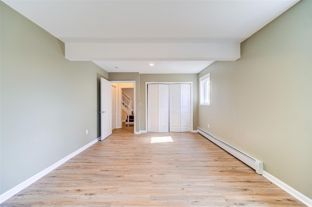 unfurnished bedroom featuring light wood-style flooring, recessed lighting, a closet, a baseboard radiator, and baseboards