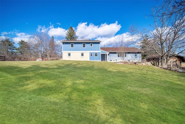 rear view of house with a yard