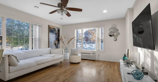 living area featuring baseboards, a ceiling fan, wood finished floors, a wall mounted air conditioner, and recessed lighting