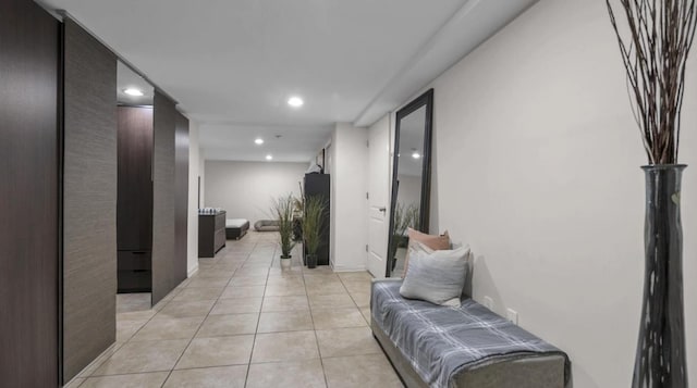 hallway with light tile patterned floors and recessed lighting