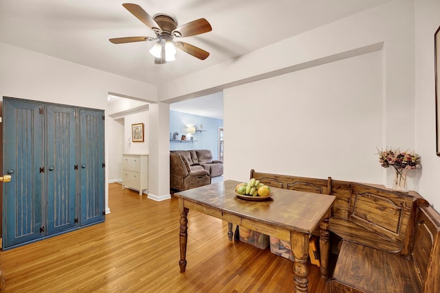 dining area with ceiling fan, light wood-style flooring, and baseboards