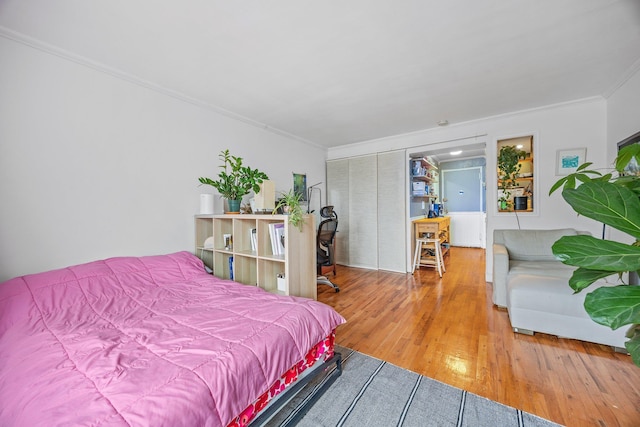 bedroom featuring crown molding and hardwood / wood-style flooring