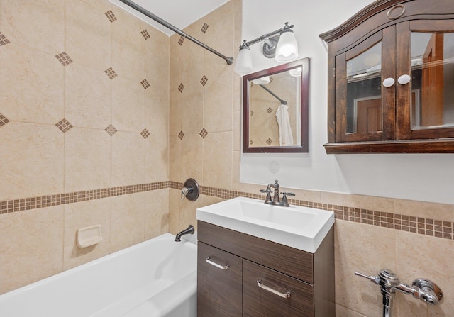 full bathroom with vanity, tile walls, and shower / tub combo with curtain