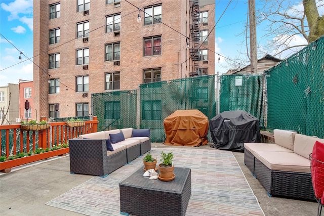 view of patio featuring an outdoor hangout area, area for grilling, and fence