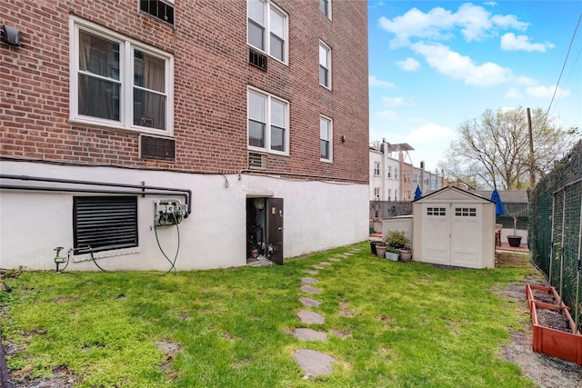 exterior space featuring a storage shed, brick siding, an outdoor structure, fence, and a lawn