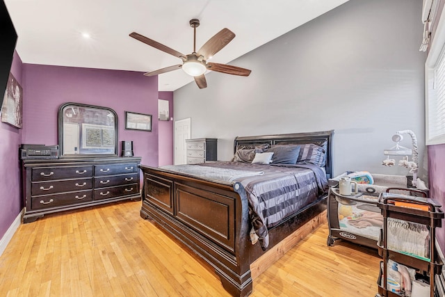 bedroom featuring a ceiling fan, lofted ceiling, baseboards, and light wood finished floors