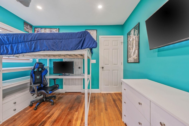 unfurnished bedroom with wood finished floors and recessed lighting