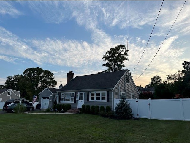 view of front facade with a chimney, a gate, fence, and a front yard