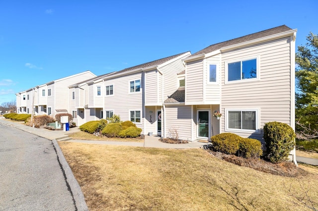 townhome / multi-family property with a front lawn and a residential view