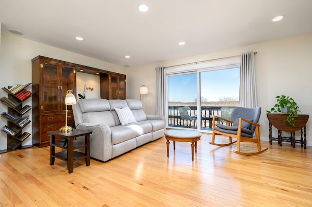 living area featuring light wood-style floors and recessed lighting