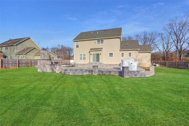 back of house featuring a patio area, a lawn, and a fenced backyard