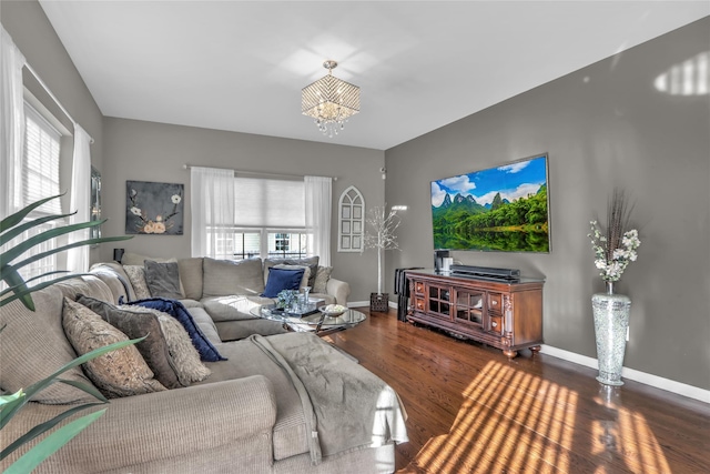 living area featuring a wealth of natural light, baseboards, and wood finished floors