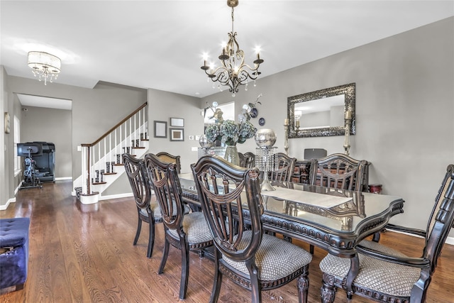 dining room with baseboards, stairway, wood finished floors, and a notable chandelier