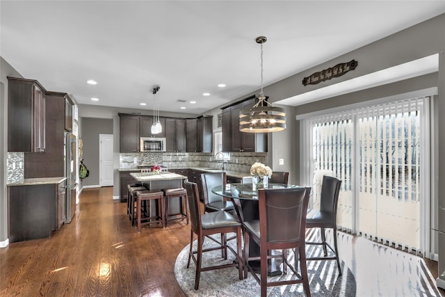 dining area with baseboards, dark wood finished floors, and recessed lighting