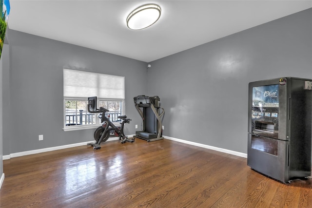 workout room with baseboards and wood finished floors