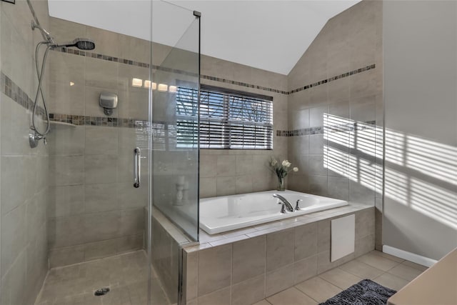 full bathroom with a garden tub, a shower stall, vaulted ceiling, and tile patterned flooring