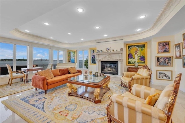 living area featuring a high end fireplace, tile patterned flooring, a tray ceiling, crown molding, and recessed lighting