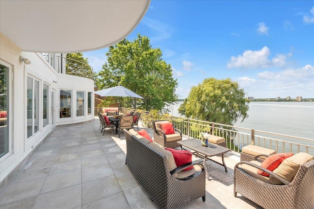 view of patio with outdoor dining space, outdoor lounge area, and a water view