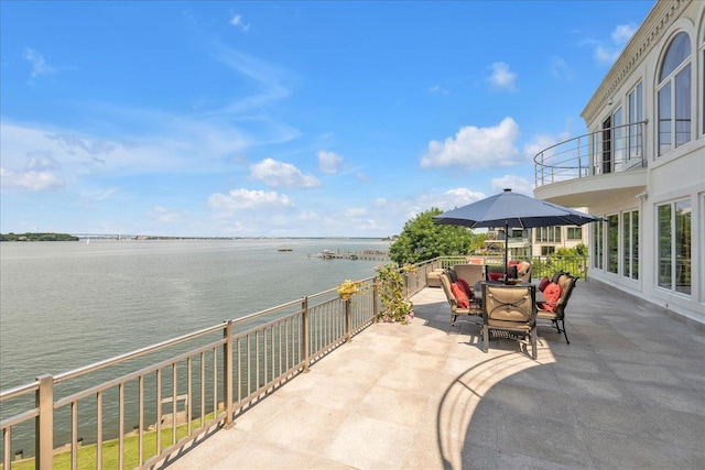 view of patio / terrace featuring a water view and a balcony