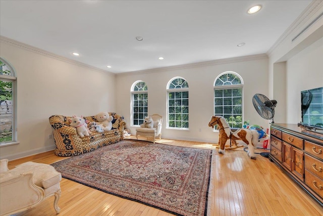 living area with light wood finished floors, baseboards, crown molding, and recessed lighting