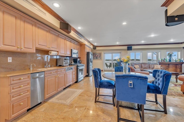 kitchen featuring ornamental molding, a sink, stainless steel appliances, backsplash, and recessed lighting