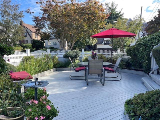 wooden terrace featuring fence and outdoor dining area