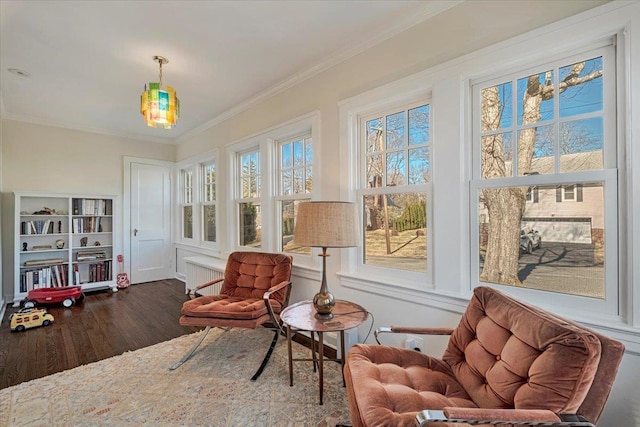 living area featuring wood finished floors and ornamental molding