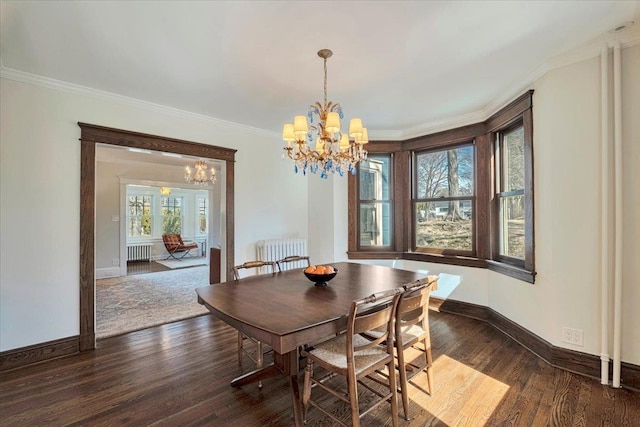 dining room with dark wood-style floors, a notable chandelier, radiator, and ornamental molding