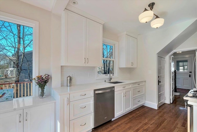 kitchen with dishwasher, decorative backsplash, light countertops, and dark wood-style flooring