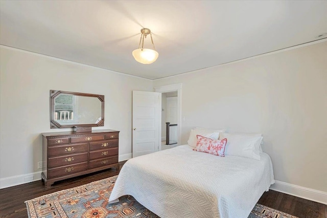 bedroom featuring dark wood finished floors and baseboards