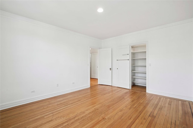 unfurnished bedroom with recessed lighting, baseboards, ornamental molding, and light wood finished floors