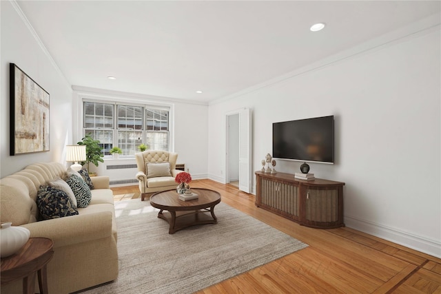 living area featuring recessed lighting, wood finished floors, baseboards, ornamental molding, and radiator