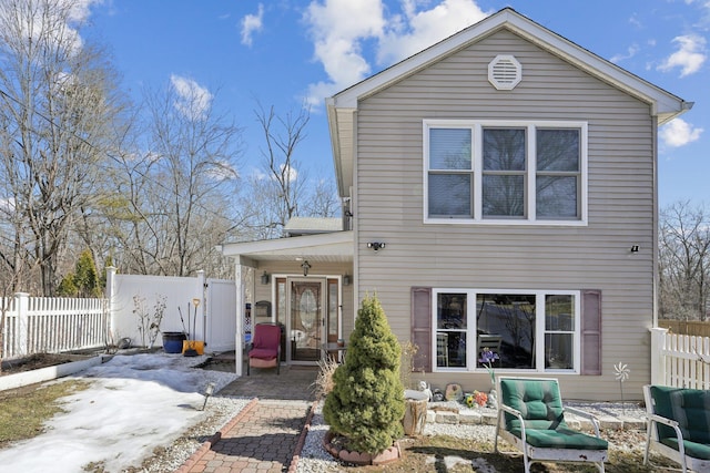 rear view of house with a patio area and fence