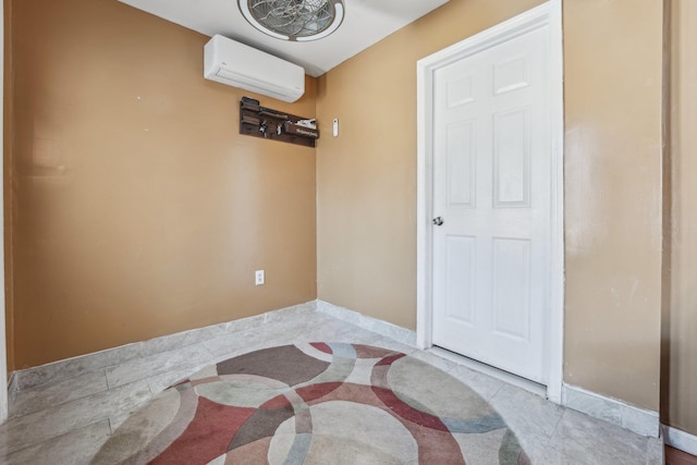 interior space with a wall mounted AC and baseboards